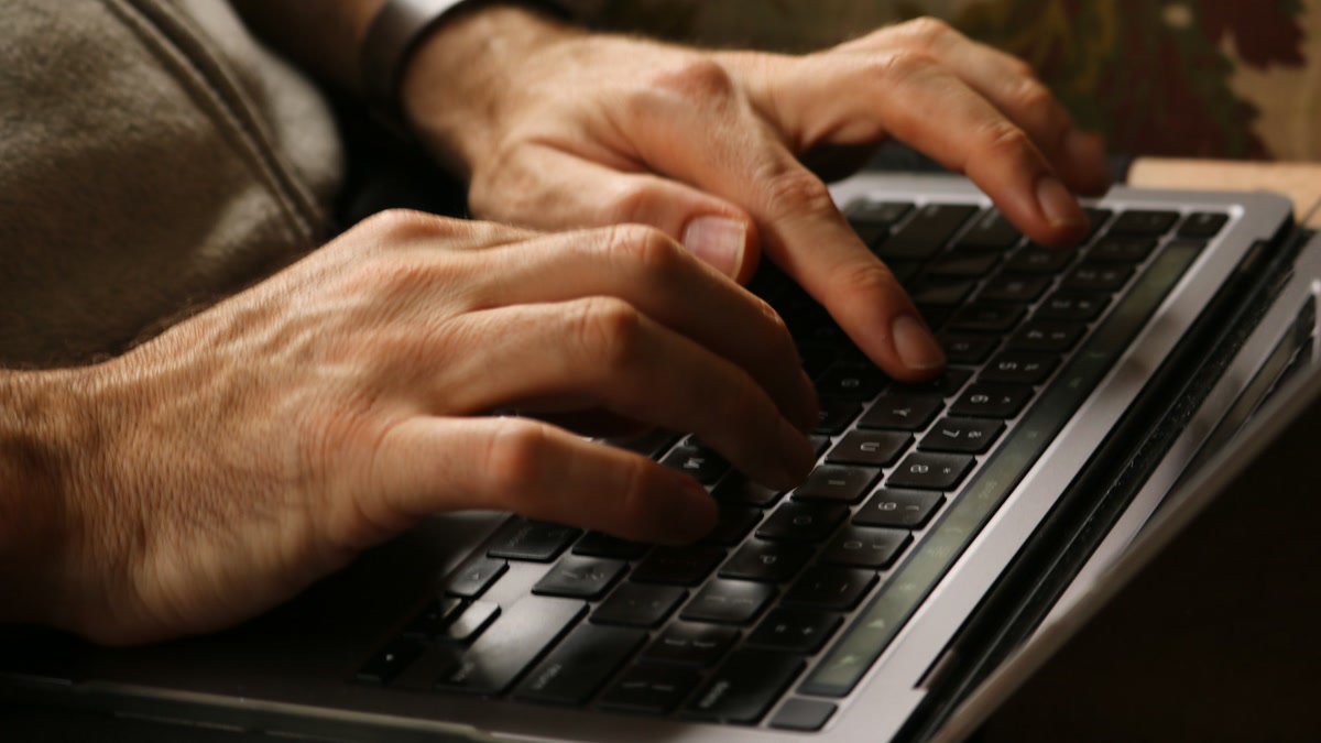 featured Hands typing on a laptop keyboard composing everyday replies