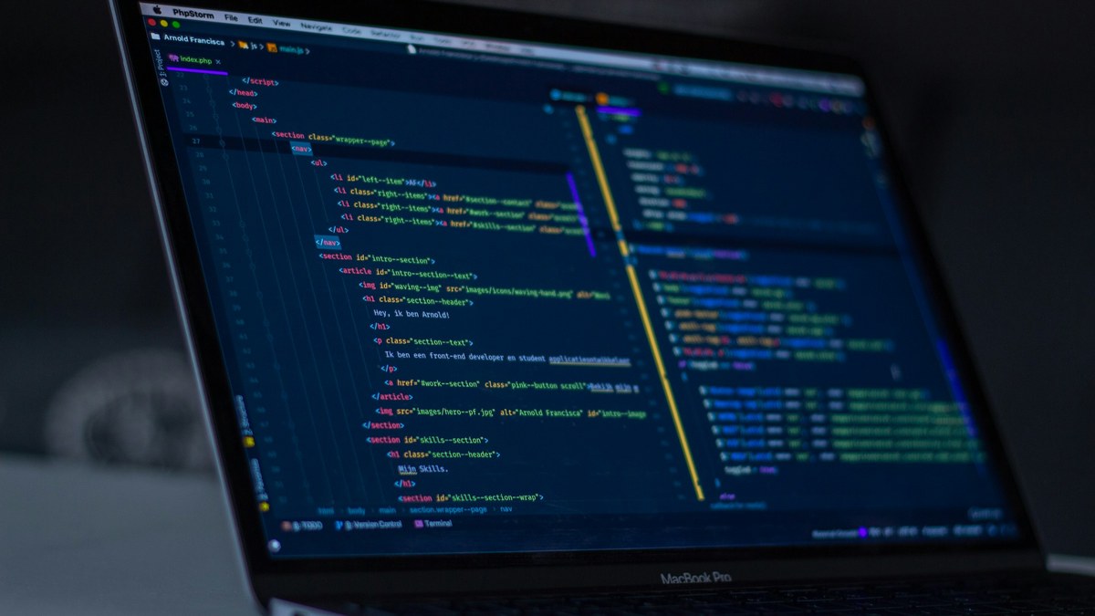 featured Laptop showing code on a freelancer desk for testing Grok 4.7 in Cursor or via API