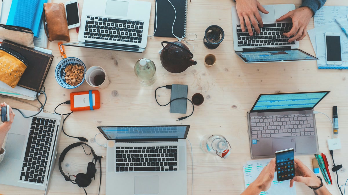 Desk setup with laptop and notebook for planning quick AI freelance jobs