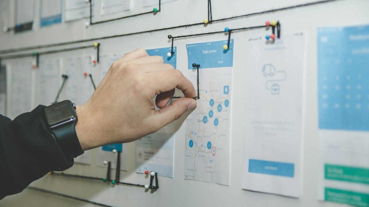 Hand arranging workflow cards on a board, illustrating moving Gemini Gems to reusable skills