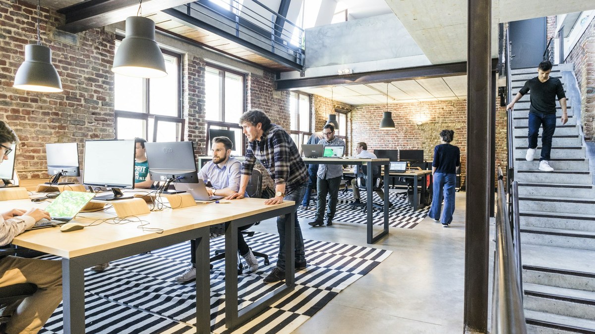 Laptop and notebook on a small-business desk for a Muse for Small Business wait-or-skip decision