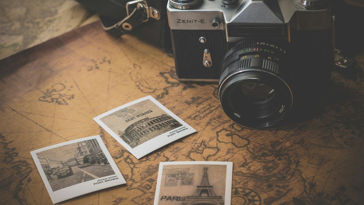 featured Vintage camera and printed photos on a desk for a SynthID Detector check-client-media decision