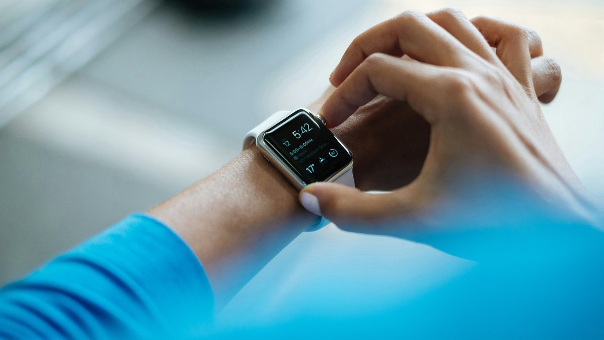 Runner checking a GPS smartwatch on their wrist for a Garmin Enduro 4 buy, wait or skip decision