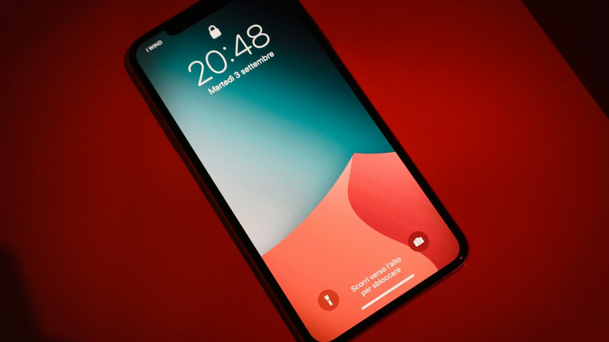 Smartphone lock screen on a red surface, illustrating a phone signal issue explainer
