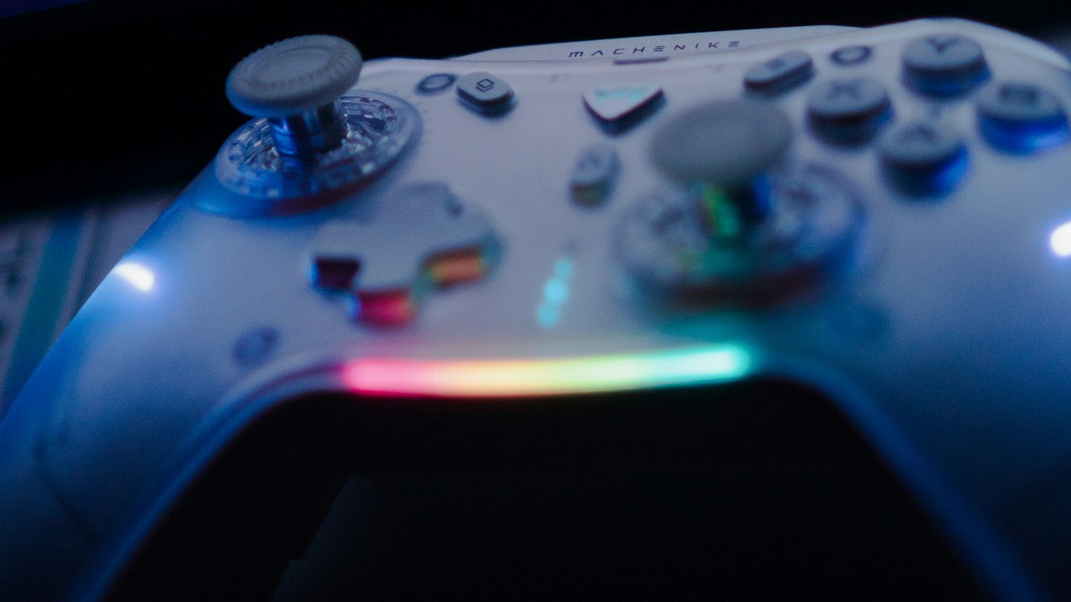 featured Game controller lit by RGB light in a dark room for a guide to PS5 jailbreak bans
