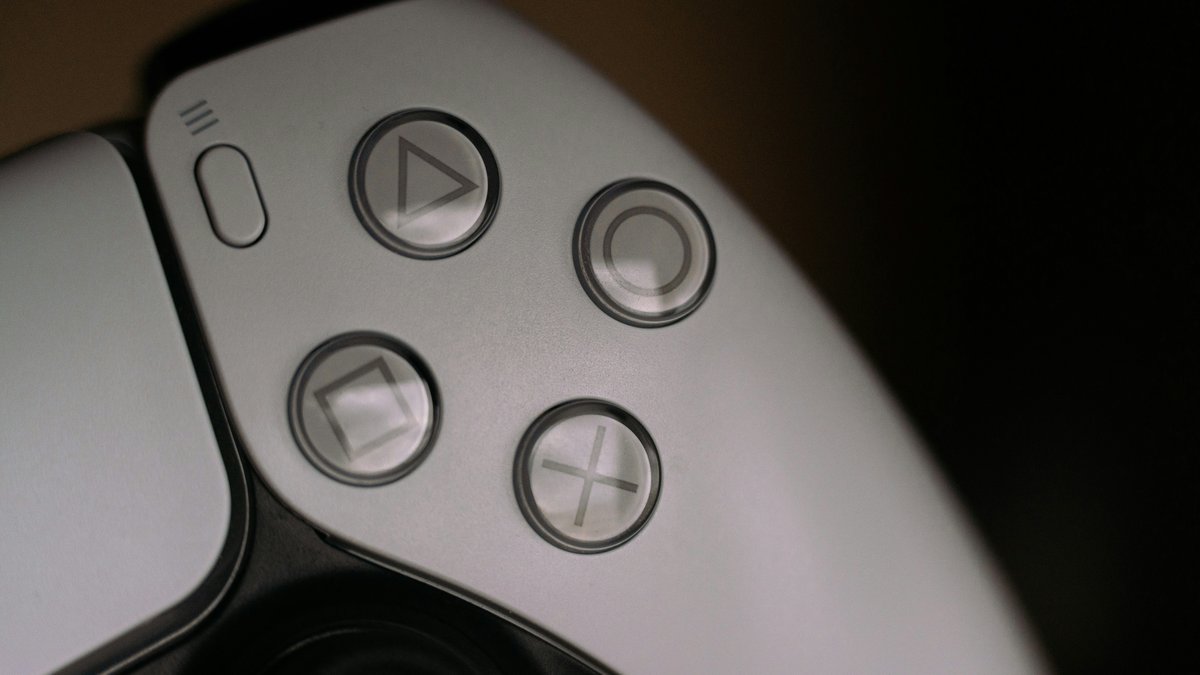 Close-up of a game controller's buttons for a guide to low-firmware PS5 listings