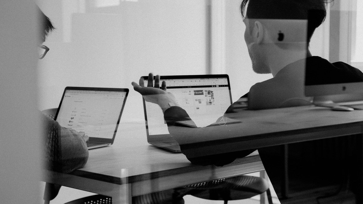 Freelancer laptop with documents and slides for Claude Docs vs Gamma try/skip
